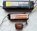 3 Magnetic Ballasts: the ballast on the top is a  Rapid start ballast, while the lower two ballasts are preheat ballasts.