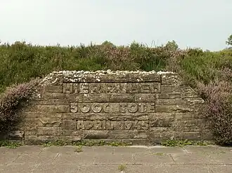 Mass grave for people killed at Bergen-Belsen concentration camp.  The engraving says "Here rest 5,000 dead.  April 1945."