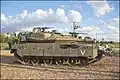 A profile of a Merkava Mk 4M tank, armed with an IMI 120 mm gun, a M2 Browning .50-cal, a 7.62x51 mm NATO commander's FN MAG, and equipped with the Trophy active protection system