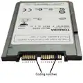 A 1.8-inch (46&nbsp;mm) micro SATA hard drive with numbered data and power pins on the connector.