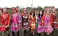 Scarved Moshka girls in traditional costumes.