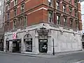 The western side of the main building has one of two entrances on Moorfields, with Moorgate visible on the extreme right in the background