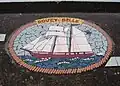 A modern mosaic made of bathroom tiles on a pavement in Wales
