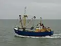 Fishing ship with a benthic dredge, leaving the port of Nieuwpoort