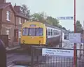 A transitional scene from BR Blue (the train) to NSE (the signage, train sticker) at Farnborough North railway station