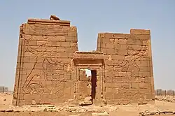Pylons depicting King Natakamani and Queen Amanitore smiting enemies. The queen holds a sword, the king an axe. Apademak Temple in Naqa.