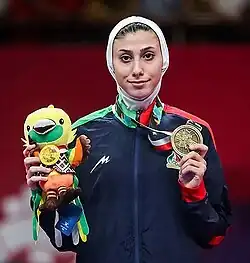 Image of Kiani holding a medal and a plushie