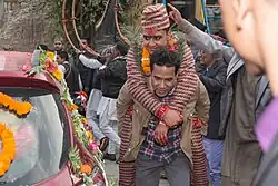 Hindu Procession in Nepal.In Nepali tradition, the "sindoor daan" (applying vermillion powder) is performed on a white cloth called "Aadar Patra", which symbolizes peace and purity, where the groom carefully applies the sindoor to the bride's forehead.