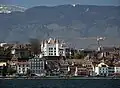 Nyon and its castle seen from the lake in spring, with the Jura mountains in the background