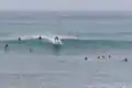 Surfers catching a wave.