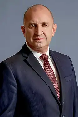 Portrait photograph of Radev, 62, wearing a black suit and a red tie.