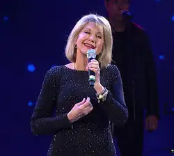 Newton-John performing in 2017