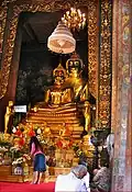 The statues of Phra Phuttha Chinnasi (front) and Phra Suwannakhet (back) in the main shrine hall. The ashes of King Rama IX are kept under the base of the statues