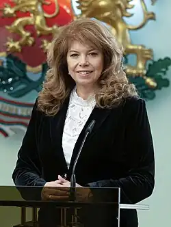 Official presidential portrait of Iotova, 61, smiling and wearing a white shirt and a blue suit jacket.