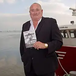 Bates in 2015 posing with his book