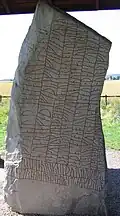The front of the stone. The beginning of the inscription is vertically at the bottom left.