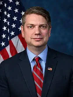 A 44-year-old man smiling at the camera.