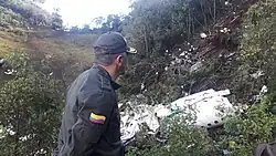 A rescue worker looking at the destroyed airplane.