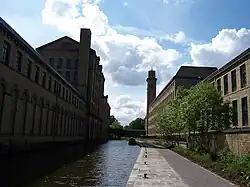 Leeds and Liverpool Canal in Saltaire — Salts Mill at the left and New Mill on the right