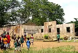 concrete walls with many children standing on the left