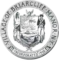 Circular seal with a central image of the coat of arms of New York, with a Native American to the left and a Colonial-era soldier to the right.