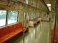 The interior of a Siemens C651 car. Modified grab poles, part of an experimental program, can be seen.