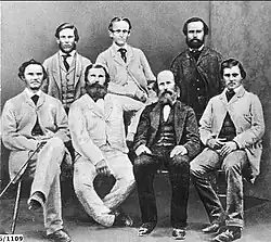 Group of men, some sitting, some standing