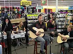 Skillet performing at a promotional acoustic show in Denton, TX