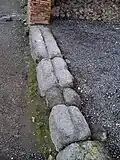 Tracks for a sliding door at a shop entrance, in Pompeii, 1st century AD