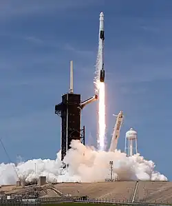 Ground-level view of a Falcon 9 lifting off from its launch pad