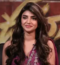 Close-up of Sreeleela wearing a patterned sleeveless top, smiling and looking to the right of the camera