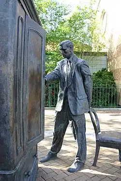 A statue of C.S. Lewis opening the wardrobe