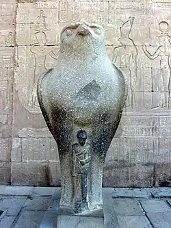 Horus statue with a smaller statue of Caesarion at temple of Edfu, Upper Egypt