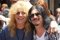 Adler (left) with Gilby Clarke at a Hollywood Walk of Fame ceremony for Slash in 2012