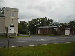 A view of Stull looking southwest. The building on the left is the former United Methodist Church, and the building on the right is an abandoned store.