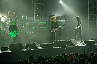The Cure performing in August 2007. From left to right: Jason Cooper, Porl Thompson, Robert Smith, and Simon Gallup