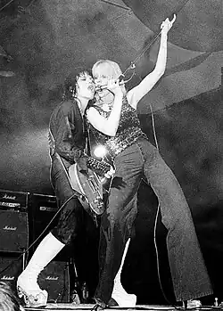 Two girls playing music at a concert.