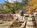 An old Balti Tibetan man in Khaplu making traditional wooden basket.