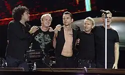Depeche Mode in concert, 2006.Other musicians Peter Gordeno (far left) and Christian Eigner (centre-left), with original members Dave Gahan (centre), Martin Gore (centre-right) and Andy Fletcher (far right).