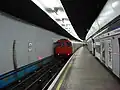 Northbound Victoria line platform with train departing