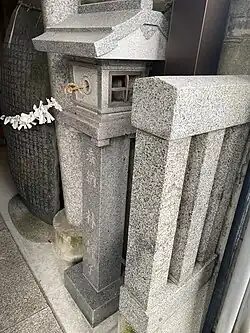 Omikuji tied over a stone stele