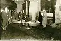 Bodies of the victims being placed in coffins on the sidewalk