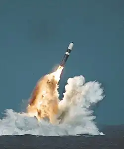 The Trident II ballistic missile as it is launched from a submarine in the ocean.