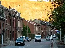 Image of a road with cars and some houses