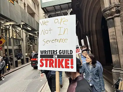 Picket line formed by writers on strike in New York City on location of Daredevil: Born Again. The picket sign references the television series Severance.