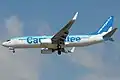 A WestJet Boeing 737-800 with a special livery promoting its customer-service promise, or "Care-antee"
