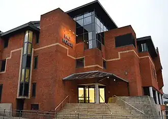 Media Molecule headquarters in a building roughly 4 or 5 floors high with a brick structure with some glass panels.