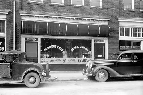 "White" and "colored" doors at a café (North Carolina, 1940)