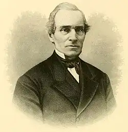 A man wearing a tuxedo with a queue haircut