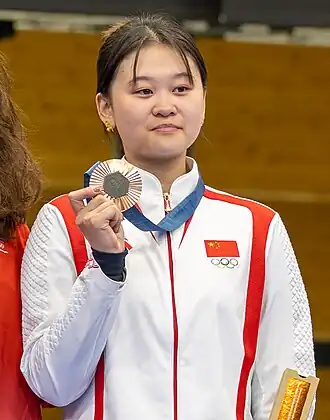 Image of Zhang holding her Olympic bronze medal